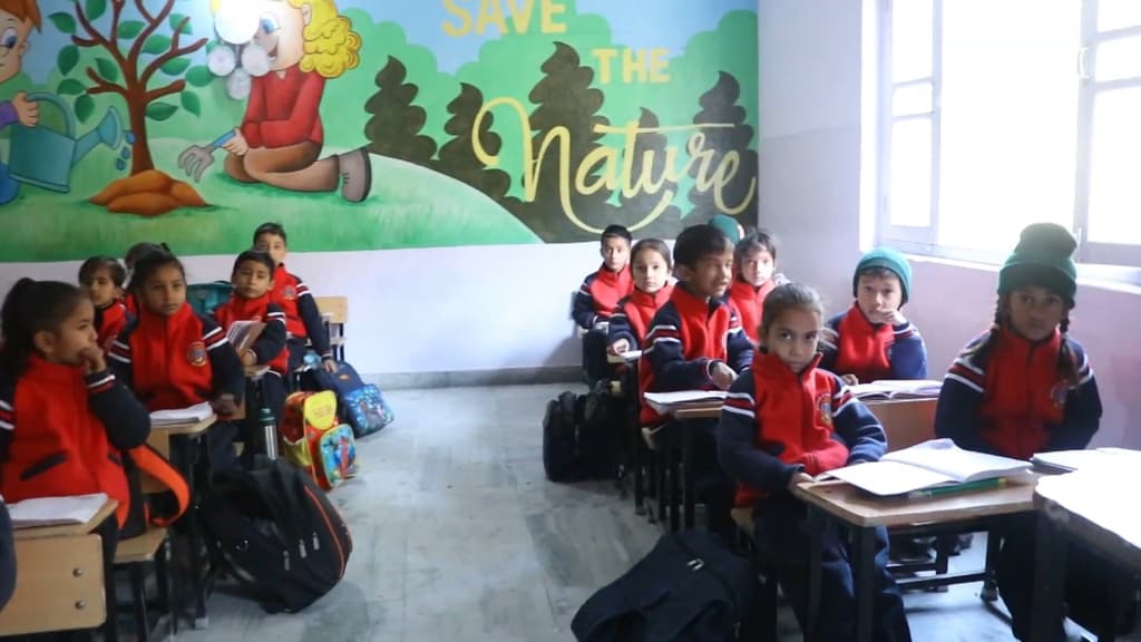 Students at their desks beneath a ‘Save the Nature’ wall mural