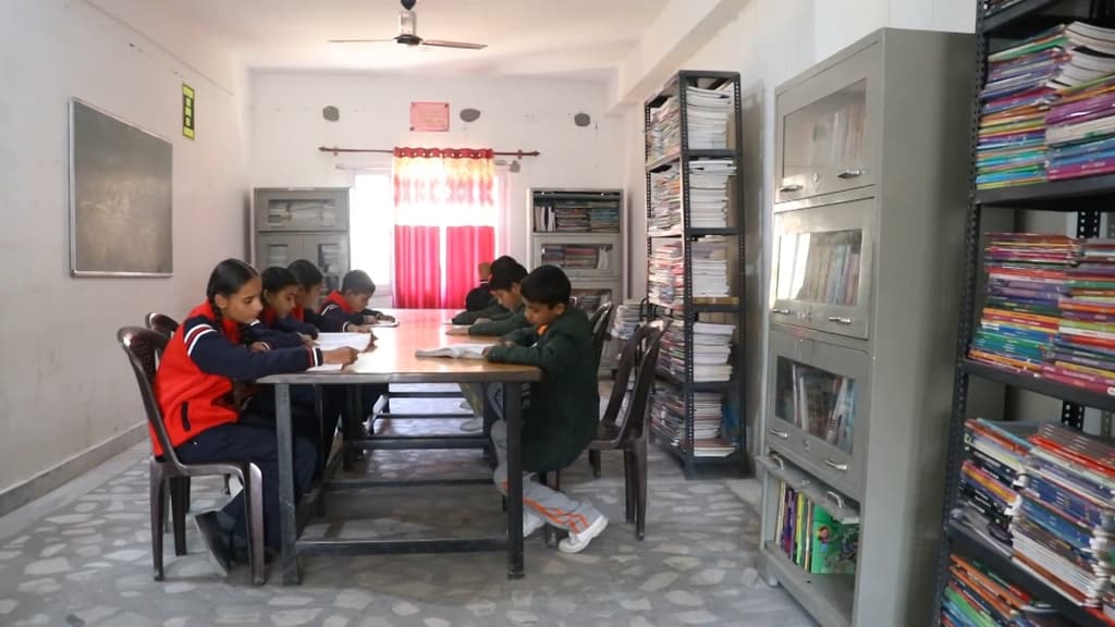 Students reading at a table in the school library