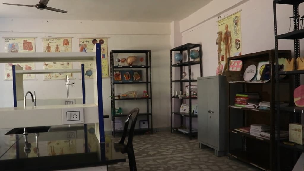 The science laboratory, with a workbench, sink and specimen shelves